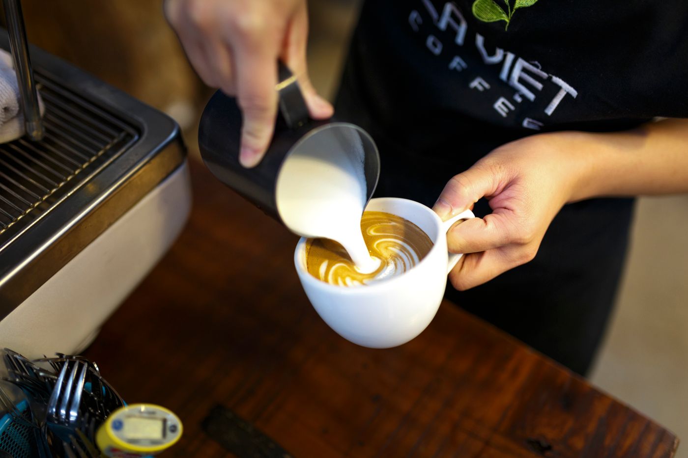 A barista making coffee at a local Brewly cafe